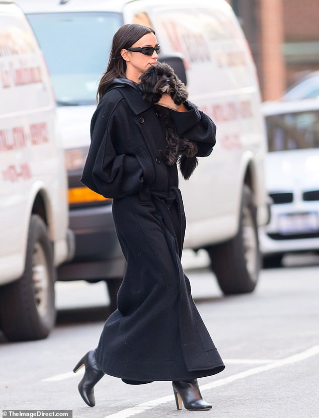 Irina looked like she had just stepped off the catwalk in her chic overcoat and black leather boots as she walked through the West Village.