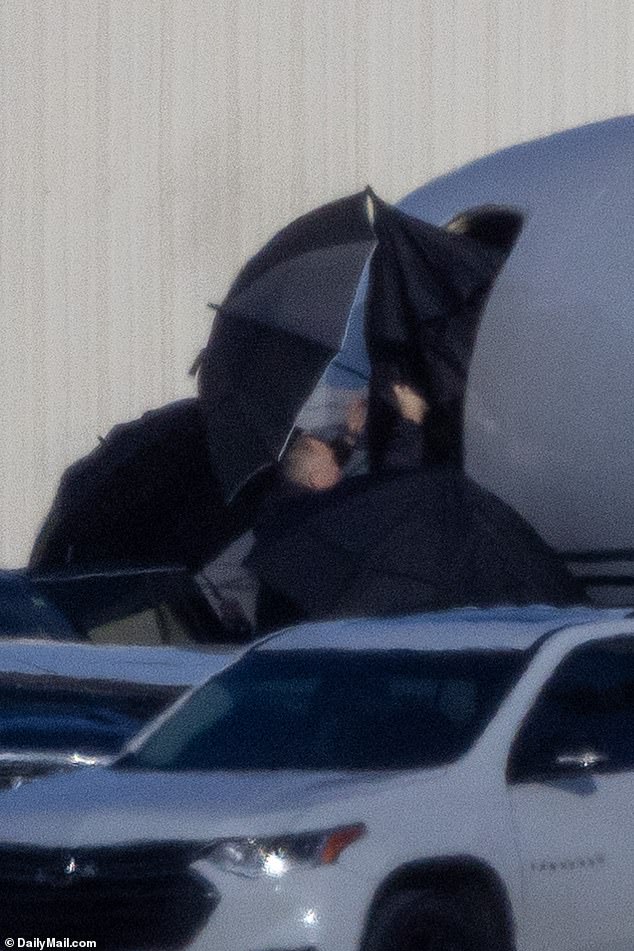 Taylor was spotted aboard her private jet under the cover of umbrellas on Tuesday morning