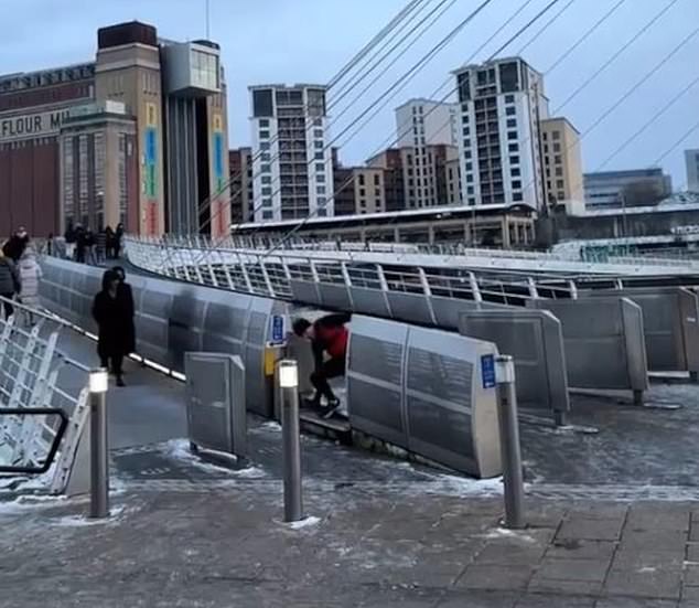 It even shows a man jogging and trying to avoid the chunk of ice as he runs along the side of it before falling down and then bouncing forward towards another barrier of the bridge.