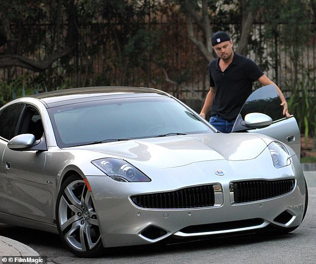 The results are likely because men and women believe there are benefits to being the partner of someone who owns an expensive car.  Pictured: Leonardo DiCaprio, 49, with a $100,000 Fisker Karma hybrid