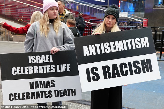 Two pro-Israel supporters held up black and white signs reading 