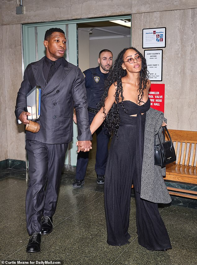 Jonathan Majors, left, and his girlfriend Meagan Good held hands as they entered the courtroom Monday