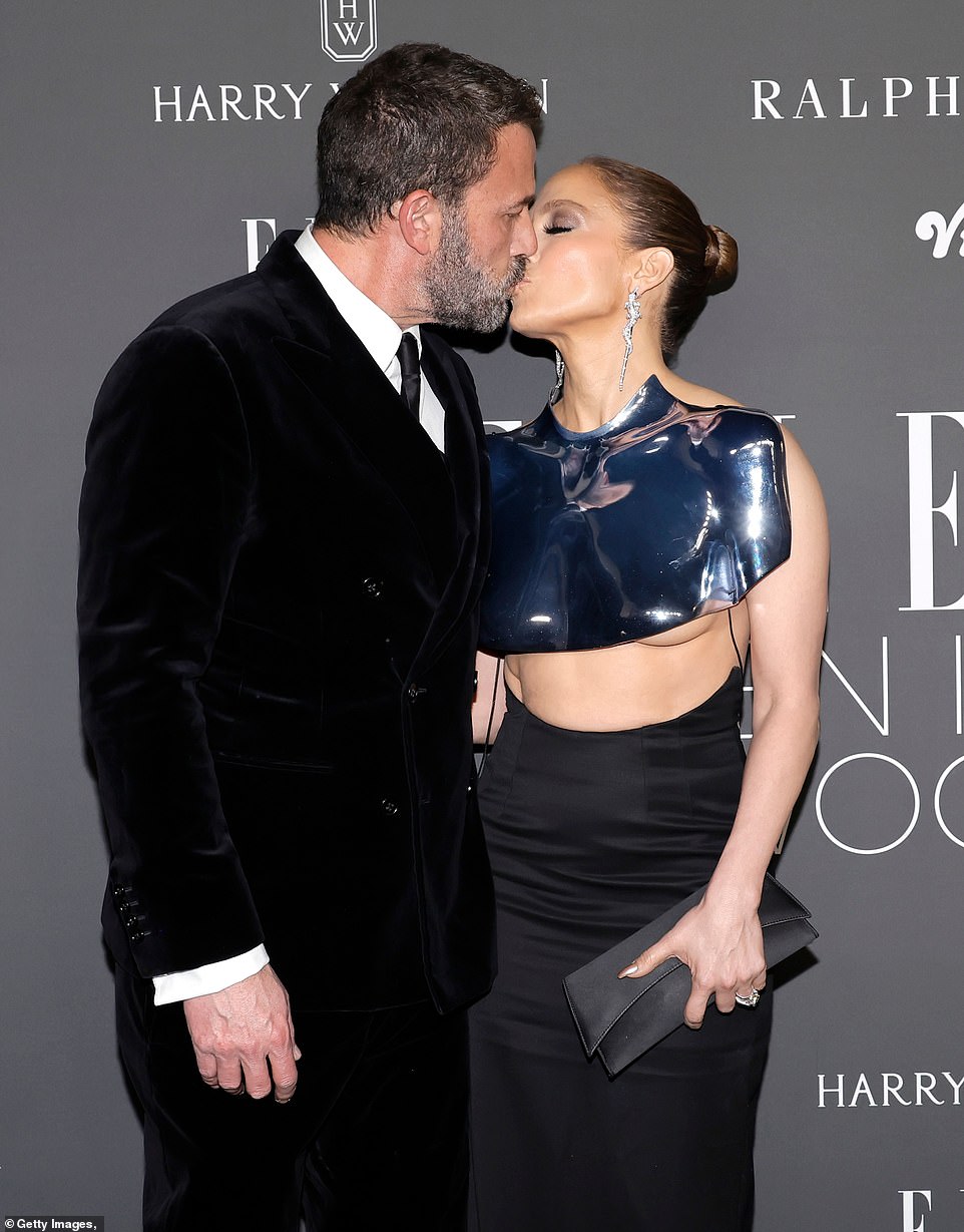 The loved-up duo shared a loving kiss in front of the shutterbugs