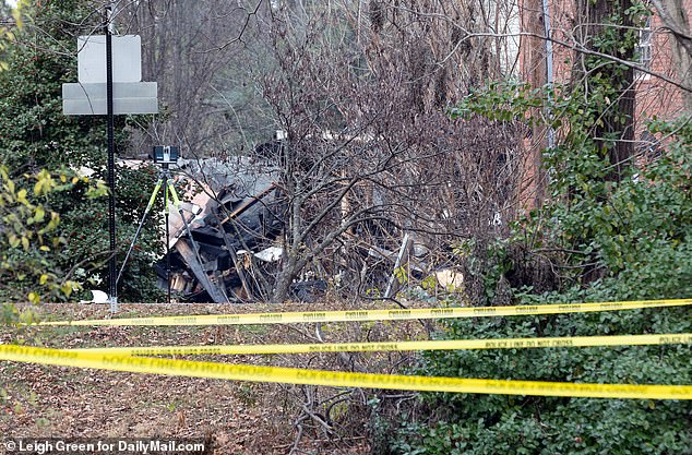 The charred remains of the house are seen on Tuesday