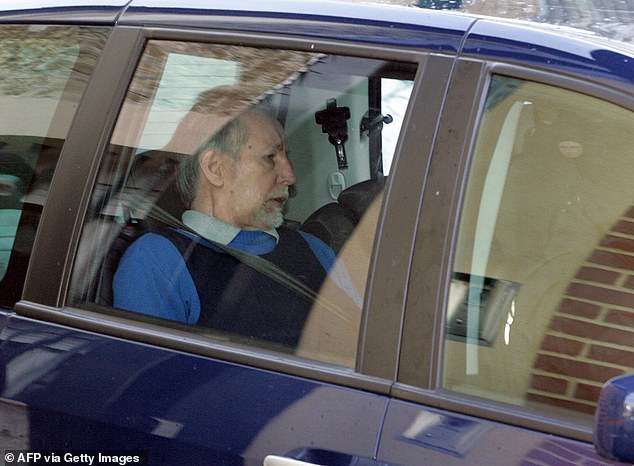 Self-confessed serial killer Michel Fourniret arrives in court in a police car at the Charleville-Mezieres courthouse on March 28, 2008