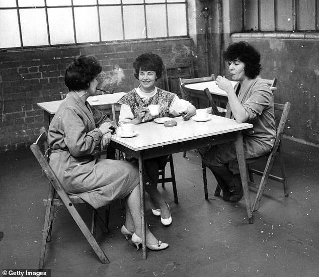 Workers at a pipe factory enjoy a cup of tea and draw on their pipes