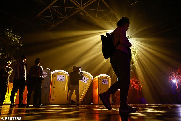 Fallen toilet stalls sprayed with bullets are part of the reconstruction of the commemoration titled '06:29' - the time Hamas launched its massive invasion on October 7.