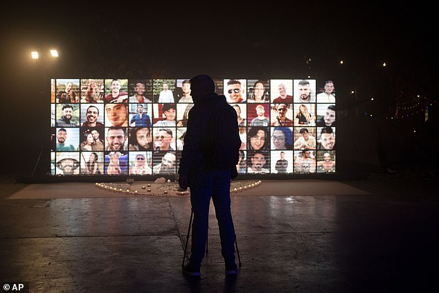 An installation projects the faces of the hundreds of revelers who died during the massacre