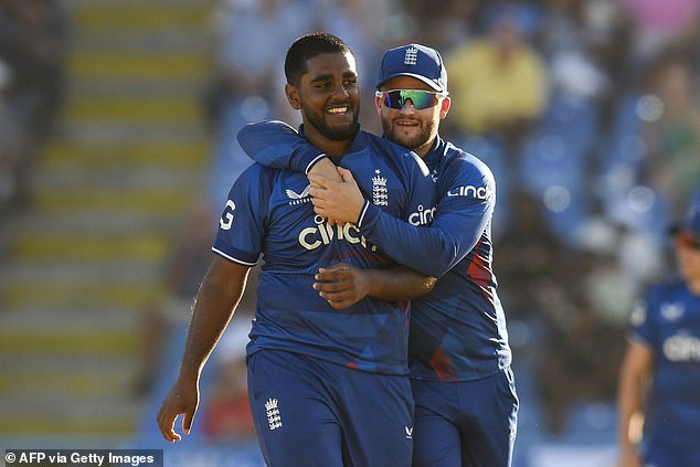 Rehan Ahmed (left) and Ben Duckett (right) celebrate the dismissal of Romario Shepherd