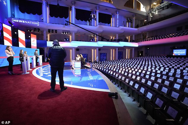 Stand-ins take place behind the debate stages prior to Wednesday night's debate at the University of Alabama's Moody Music Hall