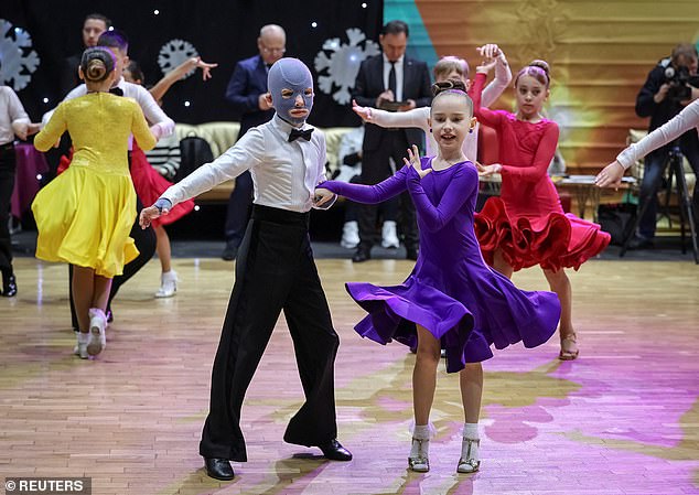 Roman demonstrated his grace as he showed off his killer moves with his partner at a school in Ukraine