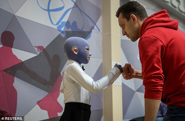 Roman's father Yaroslav gives his son a fist bump as he inspires his classmates by hitting the dance floor despite his long road to recovery from his devastating injuries