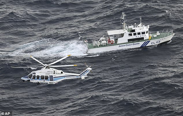 Japan Coast Guard helicopter and patrol vessel conduct search and rescue operations in the waters where a US military Osprey aircraft crashed off the coast of Yakushima Island, Kagoshima Prefecture, southern Japan, Thursday, November 30, 2023