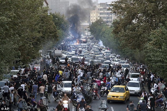 Protesters chant slogans during a protest against the death of a woman held by vice police in central Tehran, Iran, on September 21, 2022