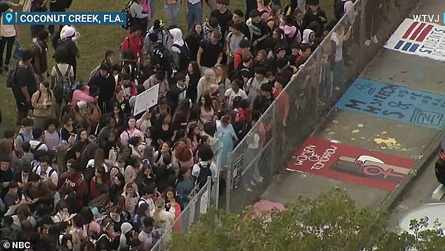 The teens waved signs in support of school staff and chanted 'trans lives matter'