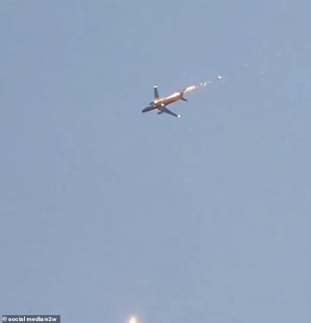 Burning fuel follows the plane as it desperately tries to land after an engine fire today