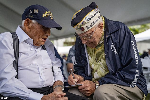 Harry Chandler, 102, (left), who raised the flag at a mobile hospital in Aiea Heights in the hills above Pearl Harbor in 1941, attended the ceremony at Pearl Harbor Thursday with other veterans