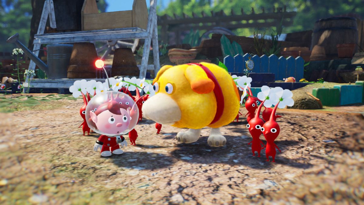 The spaceman from Pikmin 4 stands next to Oatchi the dog and a group of red Pikmin