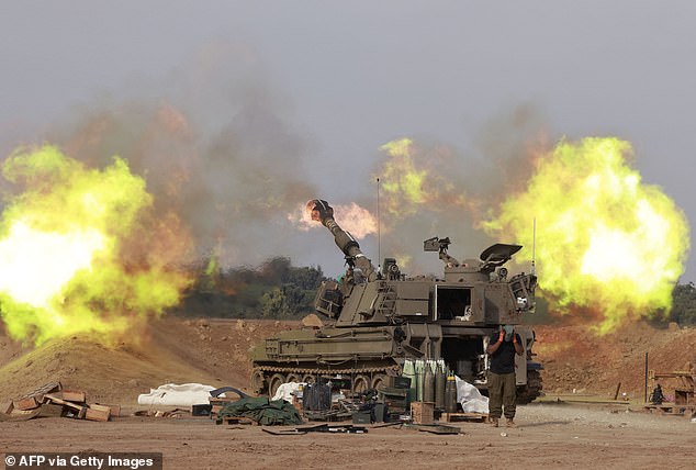 An Israeli Army self-propelled artillery howitzer fires bullets from a position near the Gaza Strip border