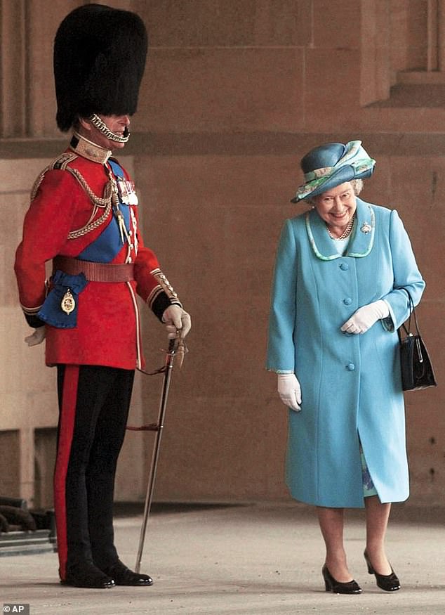 Is it something I said?  Prince Philip appears to have hit the Queen's funny bone when he posed for the ceremonial review of the Grenadier Guards at Windsor Castle in 2003