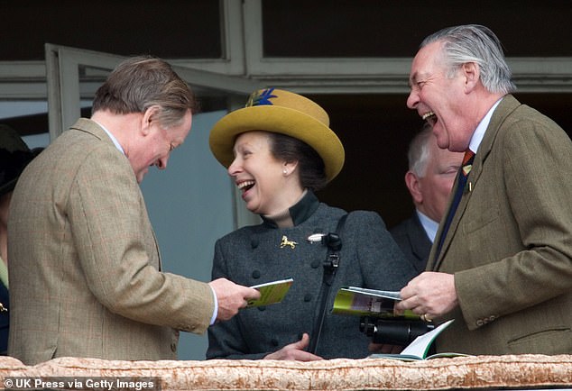 Princess Anne and Andrew Parker Bowles find something very funny at the Cheltenham Festival Race Meeting