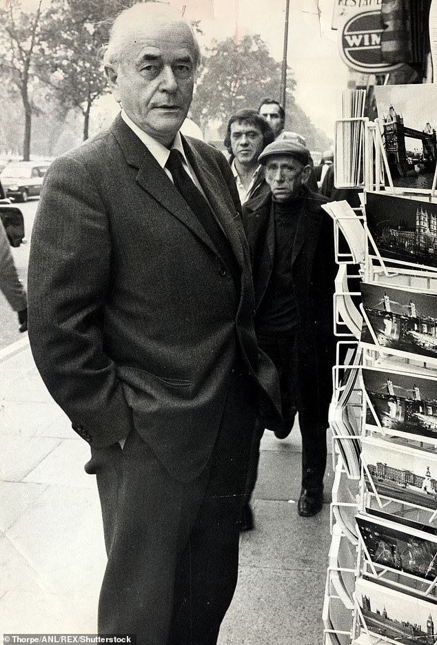 Speer looks at a rack of postcards in London during his visit in 1973