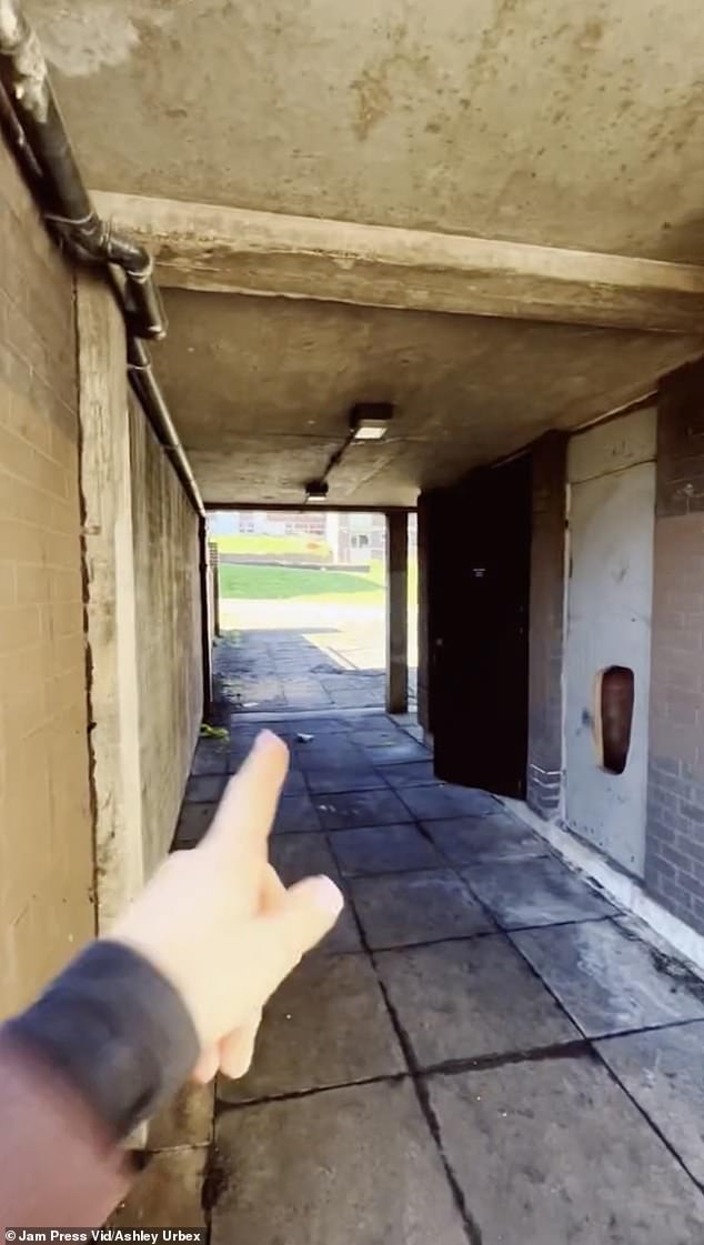 Viewers commented that it was a shame that the houses were empty due to a housing shortage.  Pictured: The urban explorer points through an abandoned passageway