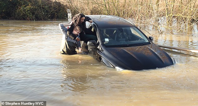 Jamie Pierce, 32, jumped in and pulled her to safety.  Her car was floating at the time