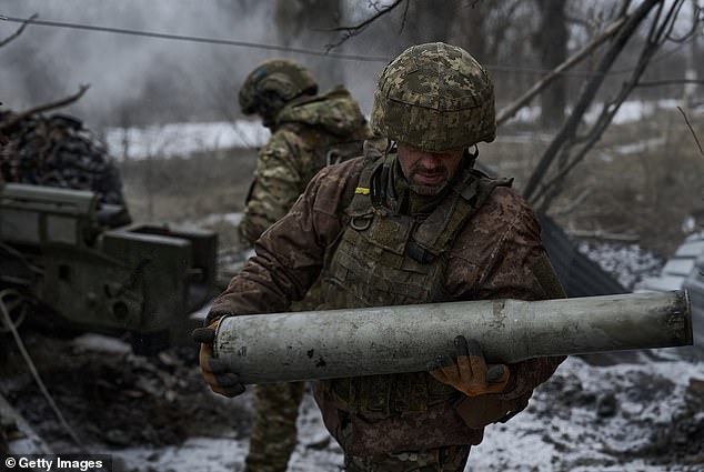 Ukrainian military soldiers fire with the MT-12 or 2A29 gun 