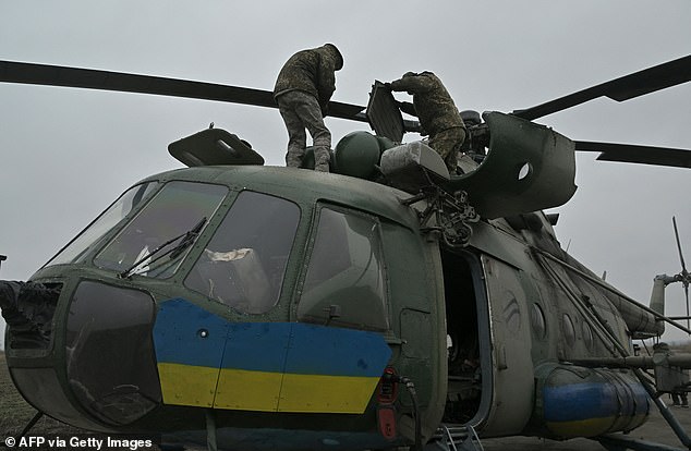 Ukrainian soldiers of an army aviation brigade prepare a Mi-8 helicopter to fly in the Donetsk region on December 7, 2023