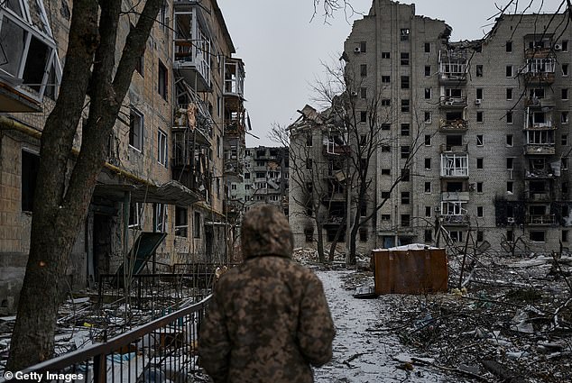 Ukrainian soldiers walk through the destroyed city in Avdiivka, Ukraine on December 7, 2023