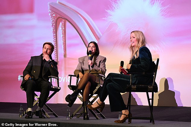 Ryan looked friendly in a black shirt and dark gray marl suit as he joined America on stage to talk about all things Barbie.