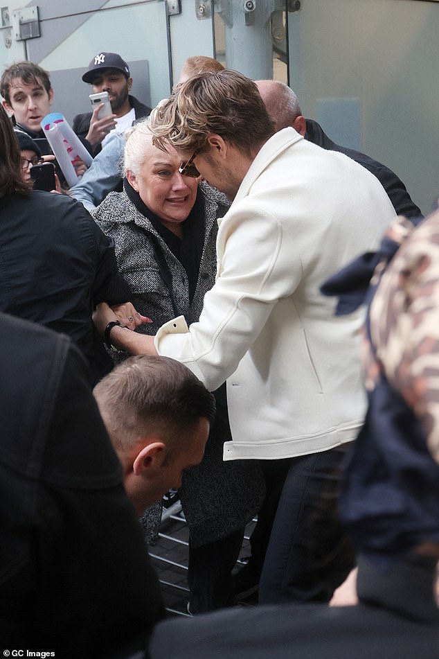 Ryan was also seen sweetly helping a fan while holding her up after a barrier fell over as crowds gathered outside the event