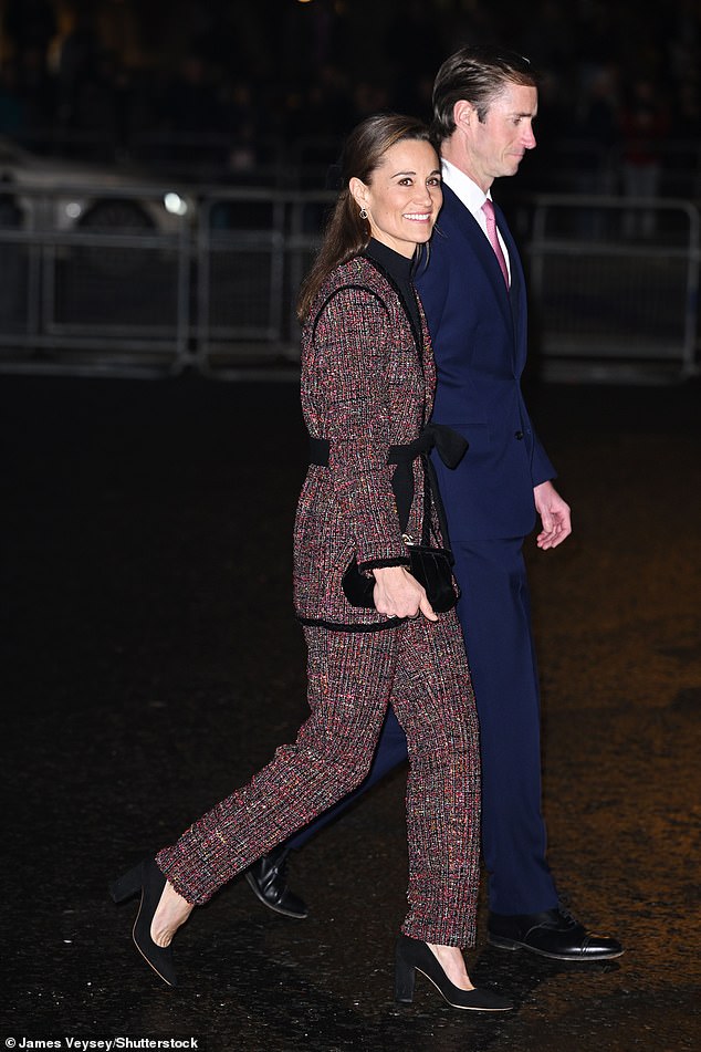 The mother of two, 40, dressed warmly in a black turtleneck under her blazer.  She completed her ensemble with suede heels and a matching designer clutch