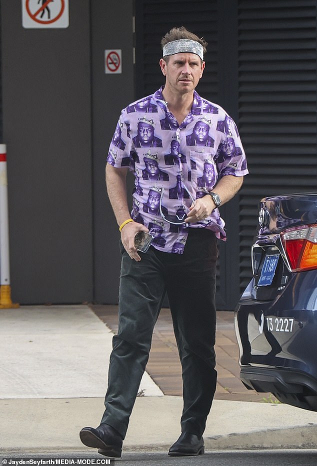 Sam Mac (pictured) appeared in good spirits, wearing a purple shirt with a Biggie Smalls print, black jeans and black boots