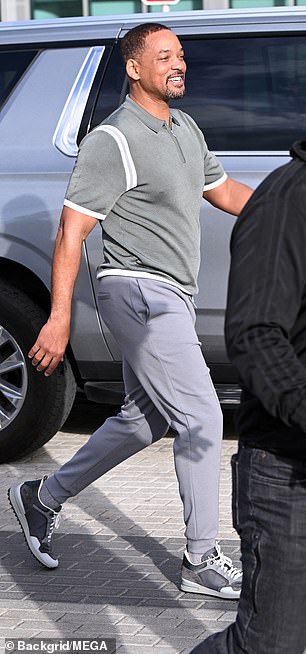 He rocked a pair of matching gray sneakers