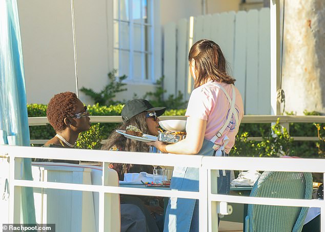 The trio sat on the picturesque terrace as they enjoyed their meal together