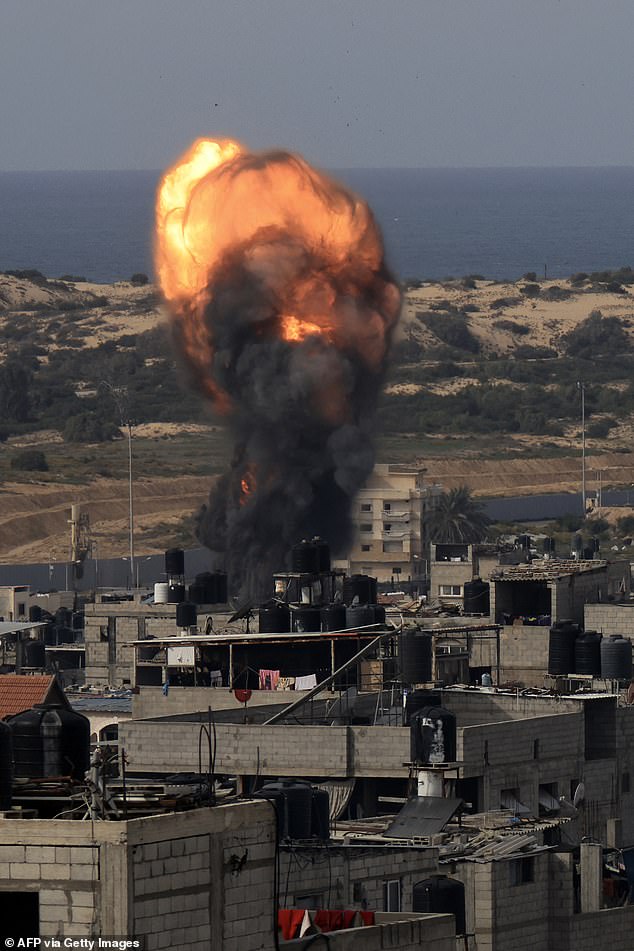 A fireball rises above a building during an Israeli attack on Saturday in Rafah in the southern Gaza Strip