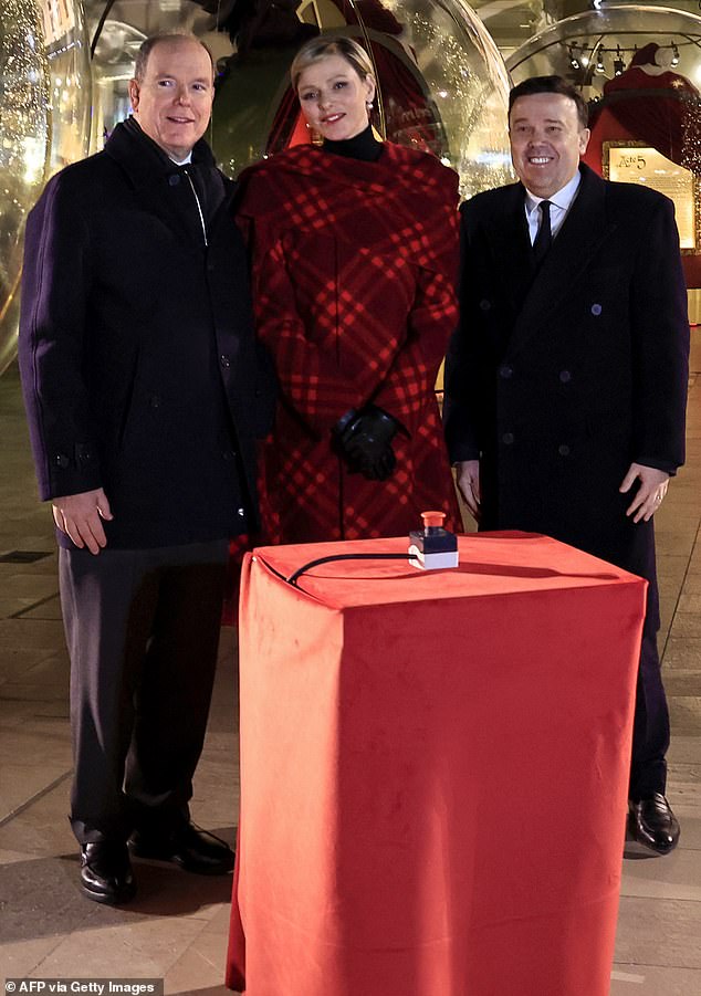 Prince Albert of Monaco (pictured, left) and Princess Charlene of Monaco (pictured, centre) with and President of Monte-Carlo Societe des Bains de Mer (SBM) Stephane Valeri (pictured, right) as they pose for a photo during the inauguration of the Christmas Village in Monaco, on December 7