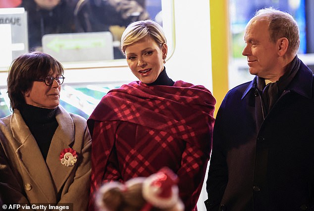 Princess Charlene (pictured, center) appeared to be deep in conversation with Princess Stephanie of Monaco (pictured, left) and Prince Albert (pictured, right)