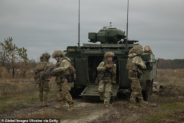 Ukrainian soldiers leave a Marder Infantry Fighting Vehicle (IFV) in Donetsk on December 7.