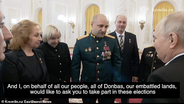 In his speech to Putin at an awards ceremony at the Kremlin, Lt. Col. Artyom Zhoga praised the president for annexing Ukraine's Donbas region and implored him to seek re-election.