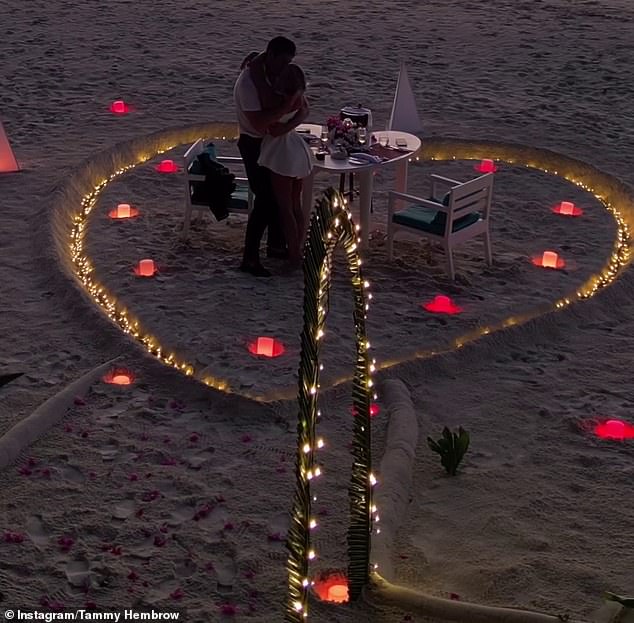 Filmed from a distance, the clip shows the lovebirds standing in a decorative love heart on the sandy shore just before Matt pops the question