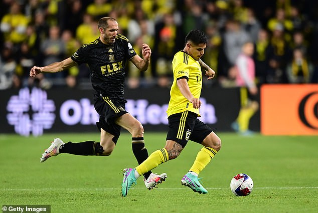 Cucho Hernandez of the Columbus Crew controls the ball while being defended by Chiellini