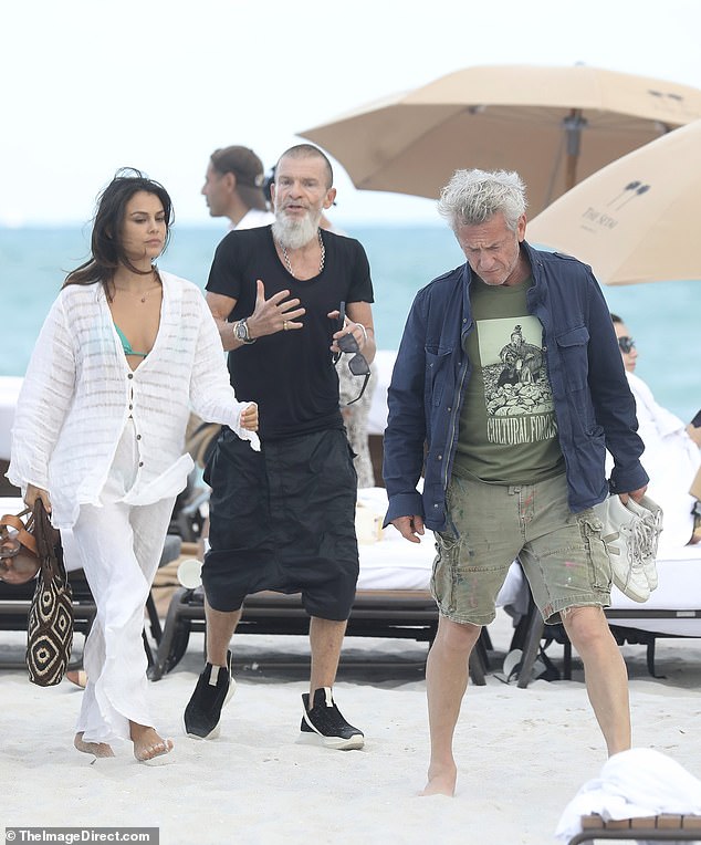 The Peruvian-Australian actress prepared for some beach time by wearing an aqua blue bikini under her sheer white ensemble, while the Oscar winner wore military green shorts with a matching T-shirt and a blue denim button-down