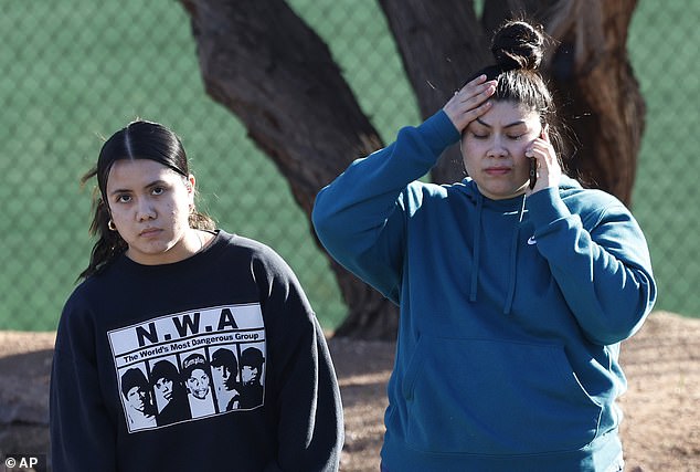 Two women are seen calling to say everything is okay after Wednesday's shooting