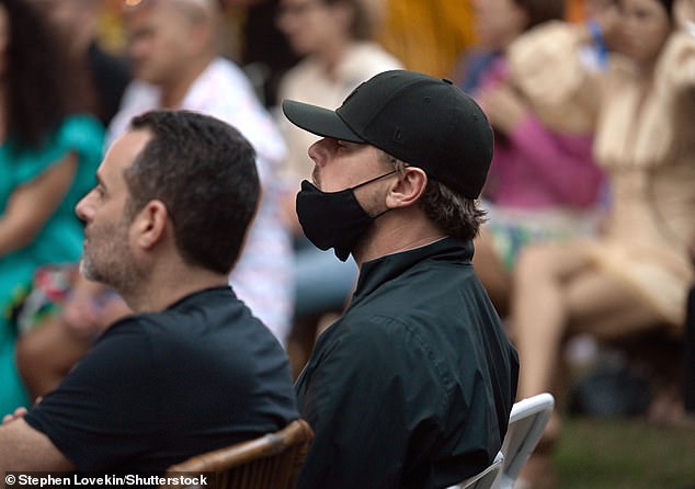 He sat in a white lawn chair as Robert spoke to the crowd