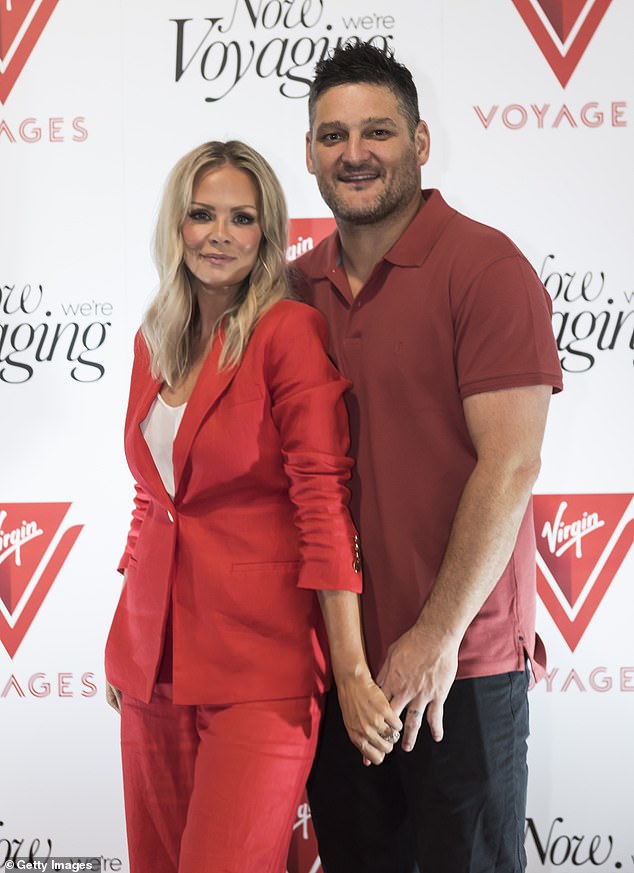 The football legend showed off his toned figure as he posed on the red carpet in a maroon shirt that showed off his built arms