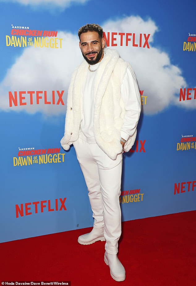 The Great British Bake Off star dressed cozy in a fur waistcoat which he threw on over an oversized white sweatshirt, matching trousers and boots