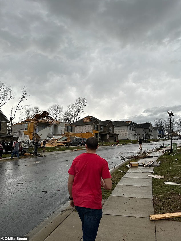 Houses have their roofs blown off, spreading debris across a residential street in Clarksville, Tennessee.  More than 20 people have been rushed to hospital after homes and businesses were damaged in several cities.